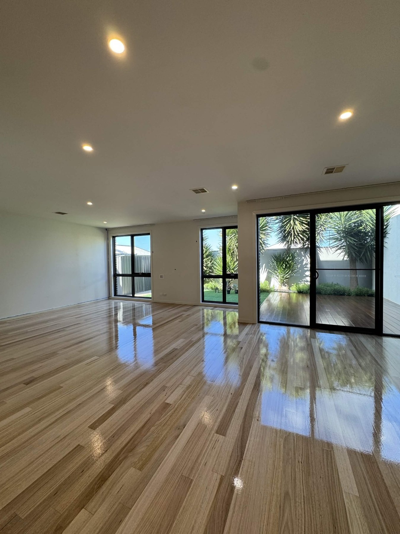 Large polished timber floor in a bright open living area