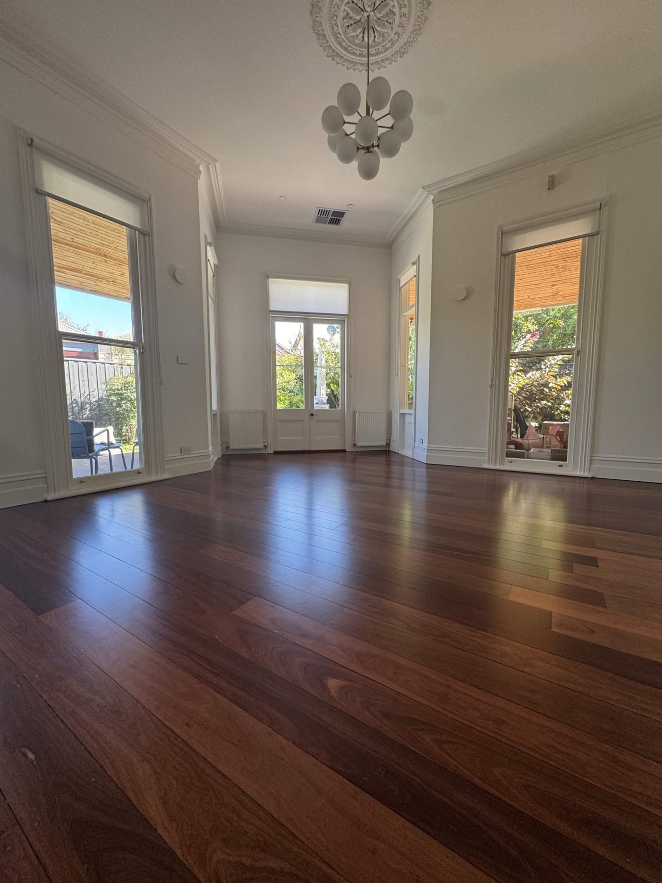 Dark polished timber floor in a bright lounge room
