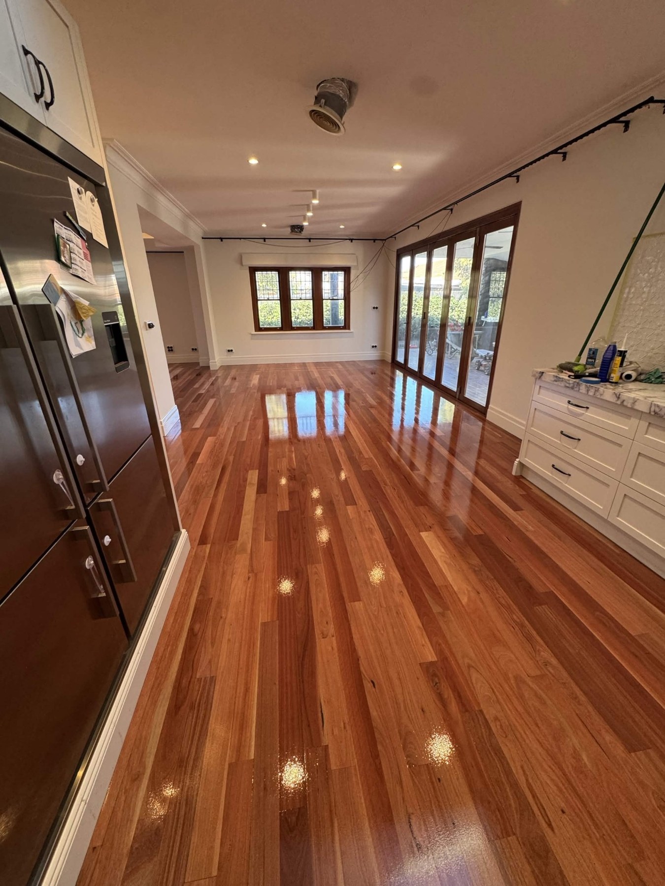 Polished timber floor through a kitchen and living room